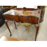 A mahogany side or dressing table, with serpentine front, two frieze drawers, on cabriole legs.