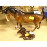 A Beswick horse, brown colourway, head right, standing, 17cm high and a recumbent foal, 915, marks