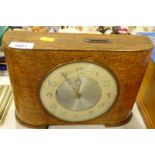 An oak cased savings clock.