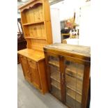 A pine dresser, and an oak bookcase with two leaded glass doors.