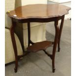 An Edwardian mahogany occasional table, with a shaped top, on cabriole legs with under tier.