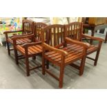 A set of four slatted wooden garden arm chairs.