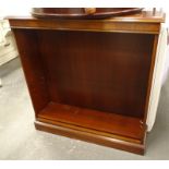 A mahogany open bookcase, with three shelves on a plinth base.