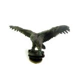 A vintage early 20thC bronze eagle car mascot, model perched with it's wings extended, 7.5cm high,