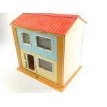 A mid 20thC wooden and plastic doll's house, with two floors, furniture and accessories.