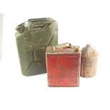 A military jerry can, olive green, dated 1966, red petroleum spirit can, and a Carr's Paints Ltd