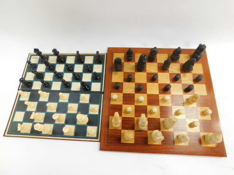 A replica resin Lewis chess set, with a wooden chess board, 47cm diameter, together with a plastic