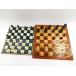 A replica resin Lewis chess set, with a wooden chess board, 47cm diameter, together with a plastic