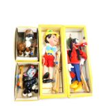 Four Pelham puppets, boxed, comprising Pinocchio, Goofy, Cat and Bengo.