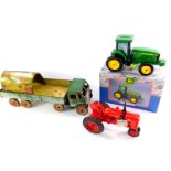 An Ertl die cast McCormick Farmall tractor, John Deere collectable savings bank modelled as a