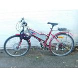 A Powabyke electric bicyle, red and silver metal chassis, with power pack and helmet.