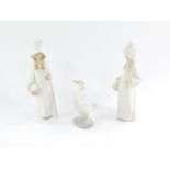 A pair of Lladro porcelain figures, modelled as girls with basket in a hooded garment, 22cm high,