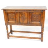 A 17thC style oak sideboard, with a pair of carved panel doors, flanking a central floral panel,