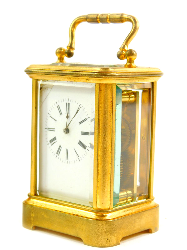 A French miniature brass cased carriage clock, enamel dial bearing Roman numerals, single barrel