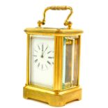 A French miniature brass cased carriage clock, enamel dial bearing Roman numerals, single barrel