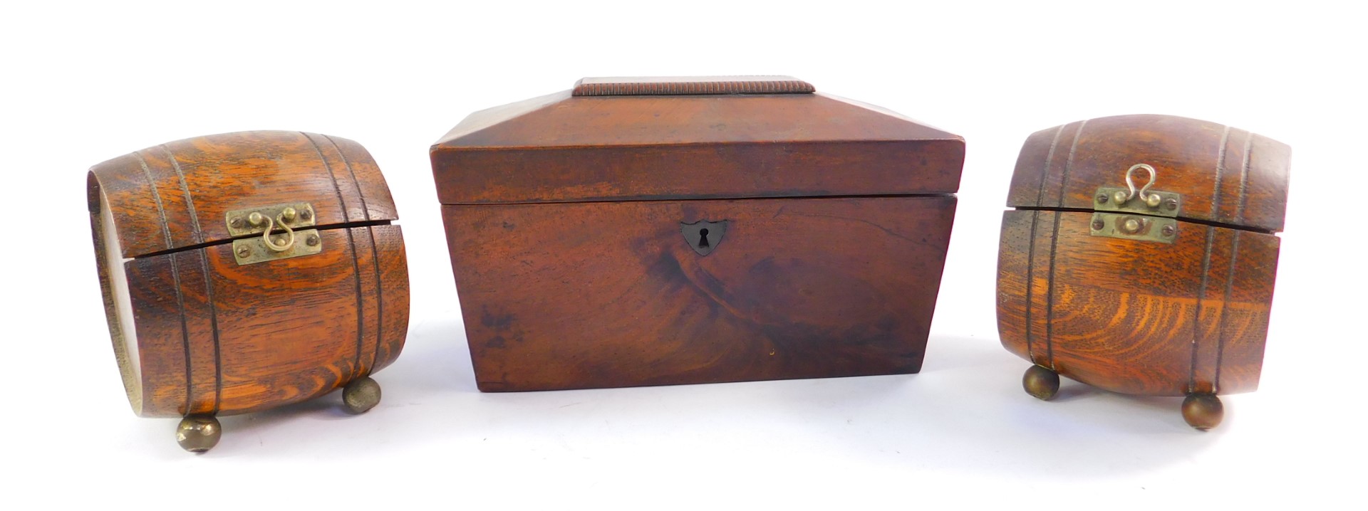 A Victorian flamed mahogany sarcophagus tea caddy, and a pair of Teopani barrel shape oak