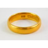 A 22ct gold wedding band, size M, 5.4g.