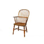 A Victorian oak and elm Windsor chair, raised on turned legs, united by a bobbin turned 'H' framed