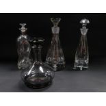 A Wedgwood grey glass decanter and stopper, two Krosno decanters and stoppers, and an hour glass