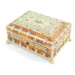 An early 20thC Anglo Indian tortoiseshell and ivory casket, with pierced panels, raised on lion's