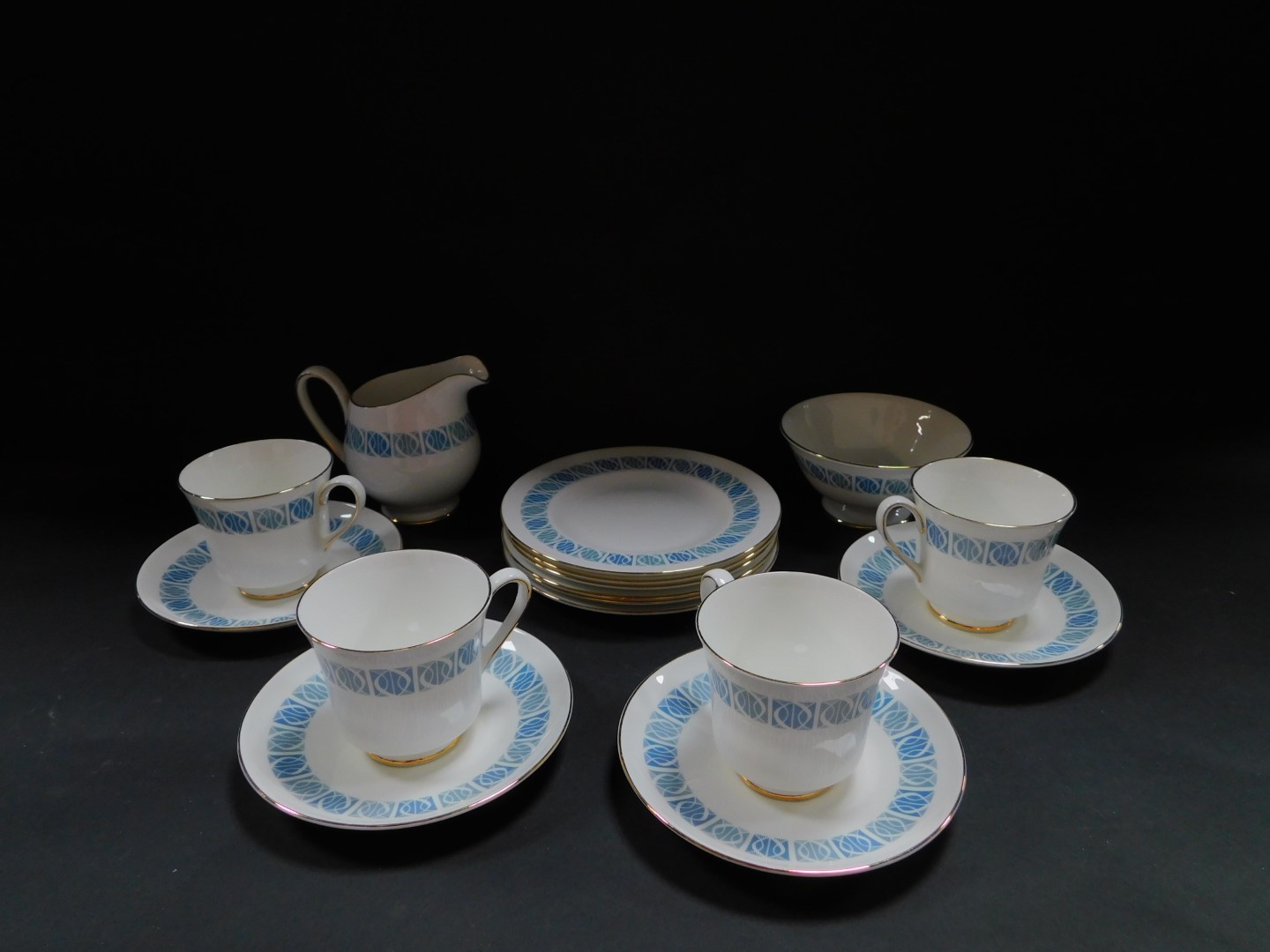 A Royal Tuscan porcelain part tea service decorated in the Contessa pattern, with blue band