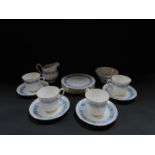 A Royal Tuscan porcelain part tea service decorated in the Contessa pattern, with blue band