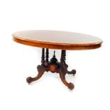 A Victorian walnut and inlaid oval tilt top breakfast table, raised on four turned columns, over