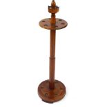 A 20thC mahogany and walnut snooker cue stand, of circular form with a crown finial, 104cm high.