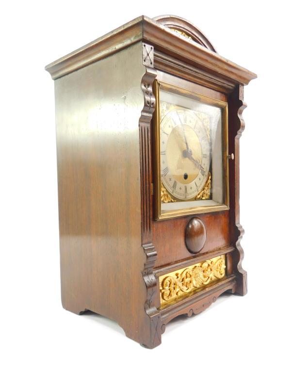 A French early 20thC oak cased mantel clock, square brass dial with foliate spandrels, silver