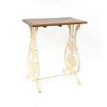 A Victorian Coalbrookdale style cast iron and beech sewing table, raised on foliate cast urn