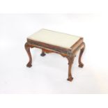 A George II mahogany stool, for upholstery, raised on carved cabriole legs, 64cm wide, 36cm deep,