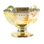 A George V silver sweetmeat dish, of octagonal fluted form, with a fluted and shell and scroll