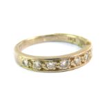 A diamond seven stone half hoop eternity ring, set in white metal, stamped 18ct, size O, 4.1g.