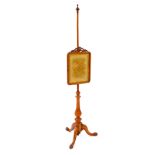 A Victorian walnut pole screen, the rectangular screen with carved shield and leaf scroll