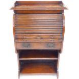 A Victorian oak student's cylinder bureau, the tambour front opening to reveal a drawer and