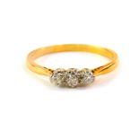 A diamond three stone ring, set in yellow metal, approx 1/8th carat, size P, 2.0g.