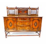 A Victorian 17thC style oak sideboard, with a carved crest rail, panelled and cane backed, over