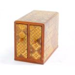 A Japanese early 20thC marquetry inlaid box, with two drawers, 8.5cm high, 6cm wide, 10.5cm deep.