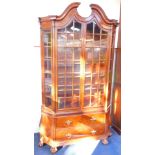A Dutch 18thC style mahogany bombe display cabinet, the broken arch pediment over two glazed doors