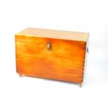 A teak chest, with cast iron handles and lock plate, opening to reveal a tray insert, raised on