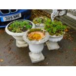 Three reconstituted stone garden urns, and a painted plastic garden vase. (4)