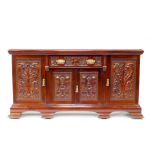 A Victorian mahogany break front sideboard, with a carved frieze drawer over a pair of carved