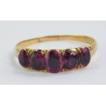 An amethyst five stone ring, set in yellow metal, size K, 1.6g.