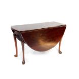 An 18thC oak drop leaf dining table, raised on cabriole legs and pad feet, 70cm high, 121cm wide,