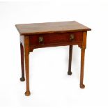 A Georgian oak side table, with a single frieze drawer raised on cylindrical legs and pad feet, 76cm