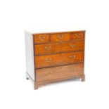 A George III oak chest of two short one medium and three long graduated drawers, raised on bracket