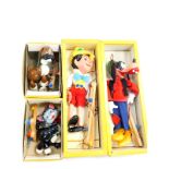 Four Pelham puppets, boxed, comprising Pinocchio, Goofy, Cat and Bengo. On initial inspection all