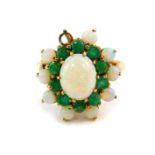 A 9ct gold opal and emerald flower head ring, in a high claw setting, size O, 3.9g, one opal