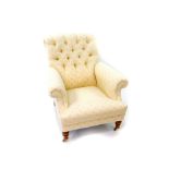 A button back nursing chair, upholstered in patterned cream fabric, raised on turned oak legs on