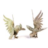 A pair of silver plated table ornaments, modelled as fighting cocks, 17cm high.